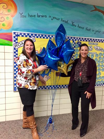 Dr. Heinz and Principal Daly with Blue ribbon award balloons